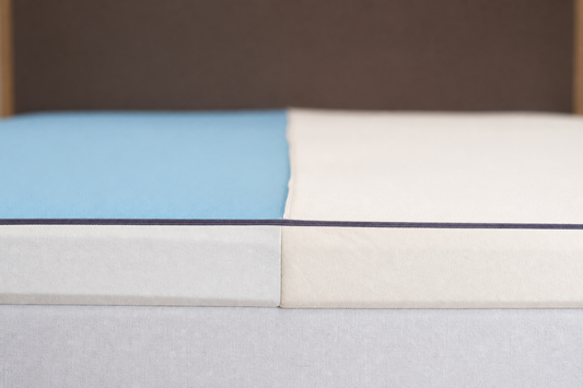 Dual firmness mattress topper insert split showing two comfort sides inside one shared bed